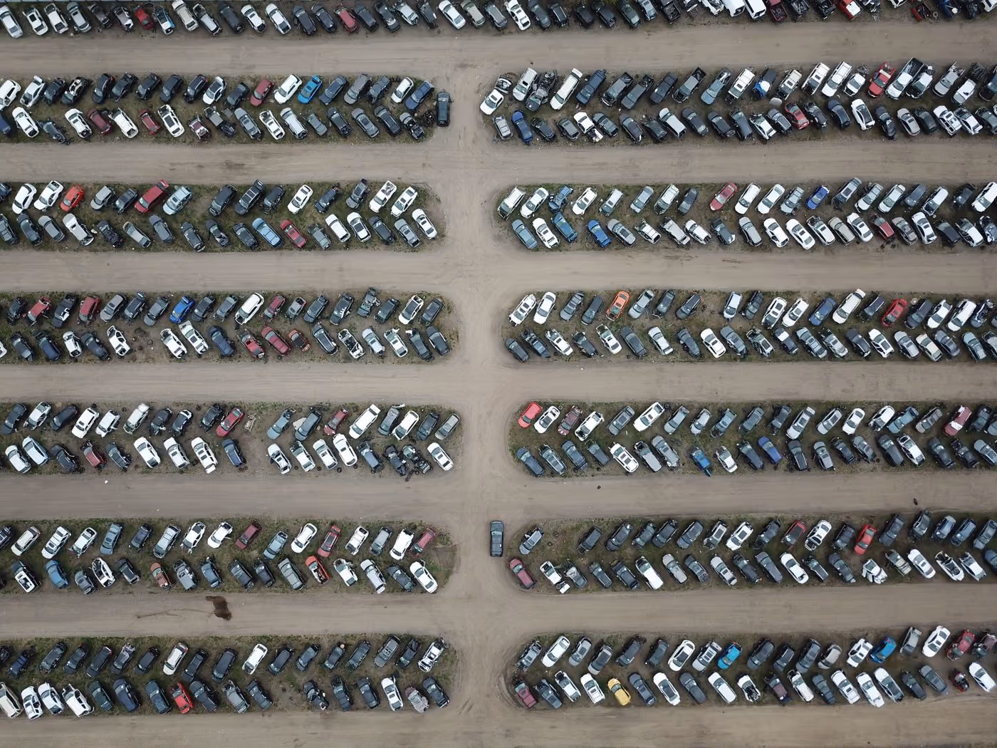 A car lot seen from above, vehicles arranged in numbered rows