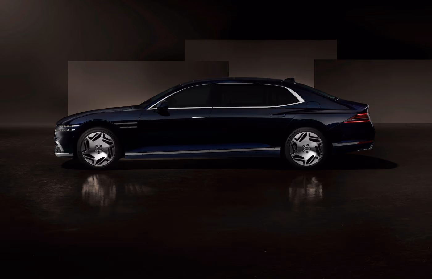 A sedan photographed side-on in a dark studio, the way a lot photo is shot for a listing